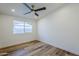 Bright bedroom with wood floors, ceiling fan and a window at 2925 E North Ln, Phoenix, AZ 85028