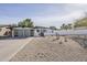 Charming single-story home featuring a modern gray garage door, xeriscaped front yard and a desert landscape at 2925 E North Ln, Phoenix, AZ 85028