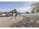 Charming single-story home featuring a modern gray garage door and a xeriscaped front yard with decorative rock at 2925 E North Ln, Phoenix, AZ 85028