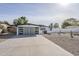 Charming single-story home featuring a modern gray garage door and a xeriscaped front yard with desert plants at 2925 E North Ln, Phoenix, AZ 85028