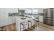 Bright and modern kitchen island with seating, stainless steel appliances, and white cabinetry at 2925 E North Ln, Phoenix, AZ 85028