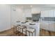 Stylish kitchen island featuring a white countertop, bar seating, and modern appliances for everyday convenience at 2925 E North Ln, Phoenix, AZ 85028