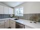 Bright kitchen features stainless steel appliances, white cabinetry, and a window over the sink at 2925 E North Ln, Phoenix, AZ 85028