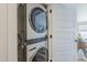 Space-saving stainless steel stacked washer and dryer near a white paneled door at 2925 E North Ln, Phoenix, AZ 85028