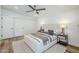 Bright main bedroom with light wood floors, a ceiling fan, and modern decor for a minimalist feel at 2925 E North Ln, Phoenix, AZ 85028