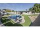 Aerial view of sparkling pool, diving board, artificial grass, and landscaped backyard at 2925 E North Ln, Phoenix, AZ 85028