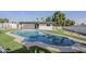 Backyard with a diving board and artificial grass surrounding an in-ground pool at 2925 E North Ln, Phoenix, AZ 85028