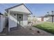 View of white shed with small patio, artificial grass, and gravel landscaping at 2925 E North Ln, Phoenix, AZ 85028