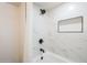 Shower with white marble tile surround, and black fixtures at 2925 E North Ln, Phoenix, AZ 85028