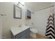 Bathroom featuring a single sink vanity, toilet, and shower/tub combination at 3333 N 81St Ave, Phoenix, AZ 85033