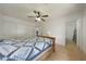 Spacious bedroom with tile floors, ceiling fan, and attached bathroom at 3333 N 81St Ave, Phoenix, AZ 85033