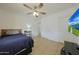 Bedroom featuring a ceiling fan, tile floors and a wall-mounted television at 3333 N 81St Ave, Phoenix, AZ 85033