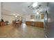 Open kitchen and dining area featuring tile flooring and wood cabinets at 3333 N 81St Ave, Phoenix, AZ 85033