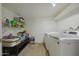 View of an indoor laundry room features washer, dryer, shelving, and additional storage space at 3333 N 81St Ave, Phoenix, AZ 85033