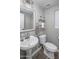 Cozy half bath featuring a pedestal sink, gray walls, and a decorative shelf at 3518 S Posse Trl, Gilbert, AZ 85297