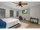 Comfortable bedroom with ceiling fan, mounted television, and a cozy leather recliner at 3518 S Posse Trl, Gilbert, AZ 85297