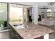 Modern kitchen island with stainless steel sink, dark cabinets, and sliding glass doors to backyard at 3518 S Posse Trl, Gilbert, AZ 85297