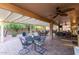 Large covered patio with multiple seating and dining areas, offering ample space for outdoor gatherings and enjoyment at 3544 N 149Th Ave, Goodyear, AZ 85395