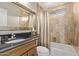 Bathroom with framed mirror, shower and tub combo, and neutral tile surround at 3544 N 149Th Ave, Goodyear, AZ 85395