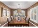 Spacious dining room showcasing a large wood table with seating for six and modern lighting at 3544 N 149Th Ave, Goodyear, AZ 85395