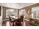 Elegant dining room featuring a wood table, modern chandelier, and wavy brown wallpaper at 3544 N 149Th Ave, Goodyear, AZ 85395