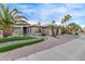 The exterior features professional desert landscaping, stonework accents and a view of a two car garage at 3544 N 149Th Ave, Goodyear, AZ 85395