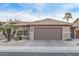 The exterior features desert landscaping, stonework accents and an attached two car garage at 3544 N 149Th Ave, Goodyear, AZ 85395