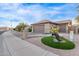 Exterior of this home shows desert landscaping, stonework accents, and multiple attached garages at 3544 N 149Th Ave, Goodyear, AZ 85395