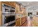 Modern kitchen with stainless steel appliances, granite countertops, and hardwood floors at 3544 N 149Th Ave, Goodyear, AZ 85395