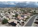 Expansive aerial view of a neighborhood featuring homes with solar panels and a mountain backdrop at 3614 W Alyssa Ln, Phoenix, AZ 85083