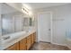 Bathroom vanity with dual sinks, tile floors, and access to a walk-in closet at 3614 W Alyssa Ln, Phoenix, AZ 85083