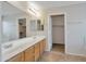 Bathroom vanity with dual sinks, tile floors, and access to a walk-in closet at 3614 W Alyssa Ln, Phoenix, AZ 85083