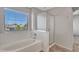 Bathroom with a large soaking tub, glass shower, and a window with natural light at 3614 W Alyssa Ln, Phoenix, AZ 85083