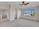 Spacious bedroom with ceiling fan, carpet floors, and an abundance of natural light at 3614 W Alyssa Ln, Phoenix, AZ 85083