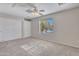 Bedroom with carpet flooring, a ceiling fan, a closet, and a bright window at 3614 W Alyssa Ln, Phoenix, AZ 85083