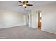 Large bedroom with ceiling fan, carpet floors, and ensuite bathroom access at 3614 W Alyssa Ln, Phoenix, AZ 85083