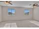 Spacious bonus room featuring dual ceiling fans and bright windows at 3614 W Alyssa Ln, Phoenix, AZ 85083