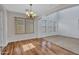 Dining room with a chandelier, hardwood floors, and multiple windows providing ample natural light at 3614 W Alyssa Ln, Phoenix, AZ 85083