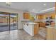 Open kitchen with stainless steel appliances, a breakfast bar, and a sliding glass door to the patio at 3614 W Alyssa Ln, Phoenix, AZ 85083