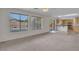 Bright living room with carpet, multiple windows, and open kitchen concept at 3614 W Alyssa Ln, Phoenix, AZ 85083