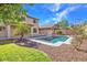 Relaxing backyard oasis with a sparkling pool, grassy area, and easy-care desert landscaping at 3614 W Alyssa Ln, Phoenix, AZ 85083