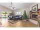 Spacious living room features a brick fireplace, a ceiling fan, and tile flooring at 3720 E Vista Grande --, San Tan Valley, AZ 85140