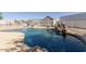 A kidney-shaped pool features a rock waterfall and a concrete deck enclosed by white fencing at 3720 E Vista Grande --, San Tan Valley, AZ 85140