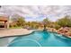 Beautiful pool with basketball hoop, putting green and water feature at 4365 E Milton Dr, Cave Creek, AZ 85331