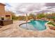 Outdoor oasis featuring a sparkling pool, relaxing hot tub, and lush landscaping for ultimate backyard enjoyment at 4365 E Milton Dr, Cave Creek, AZ 85331