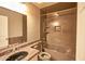 A full bath features a shower/tub combo with dark tile surround and a matching vanity with granite countertop at 4365 E Milton Dr, Cave Creek, AZ 85331