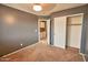 An inviting bedroom with neutral walls and carpet, with a ceiling fan, window, closet and an open door to bathroom at 4365 E Milton Dr, Cave Creek, AZ 85331