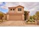 Two-story house with tile roof, desert landscaping, and two-car garage enhancing the property's curb appeal and functionality at 4365 E Milton Dr, Cave Creek, AZ 85331