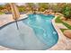 Sparkling pool with cleaner, waterfall, and putting green for backyard fun at 4365 E Milton Dr, Cave Creek, AZ 85331