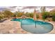 Backyard pool with rock waterfall feature and mature landscaping at 4365 E Milton Dr, Cave Creek, AZ 85331